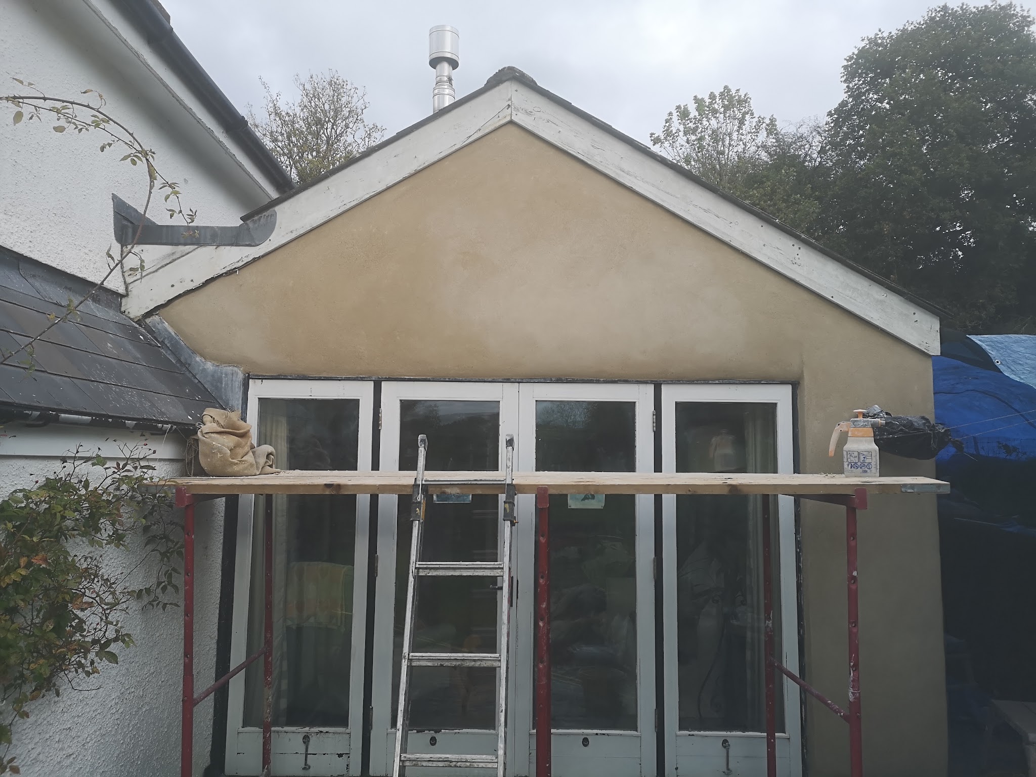 A rear extension gable freshly rendered above bi-fold doors