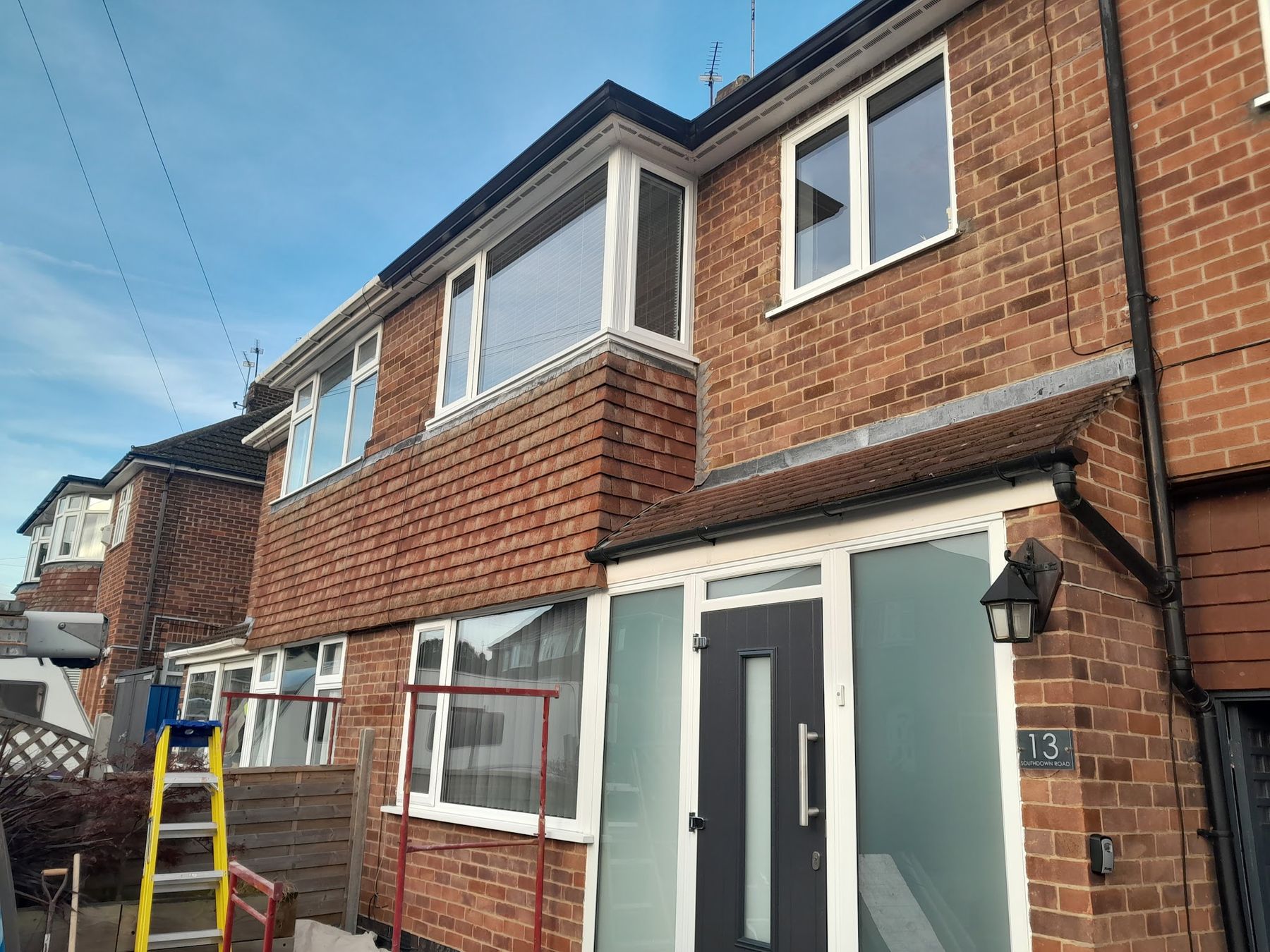 The front of a brick semi-detached house during an exterior job